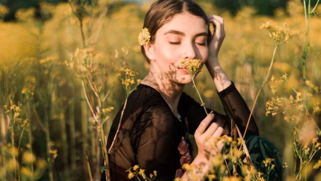 girl-smelling-flowers